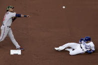 Minnesota Twins second baseman Jorge Polanco (11) throws to first after forcing Kansas City Royals' Andrew Benintendi (16) out at second on a force out hit into by Bobby Witt Jr. (7) during the first inning of a baseball game Saturday, May 21, 2022, in Kansas City, Mo. (AP Photo/Charlie Riedel)