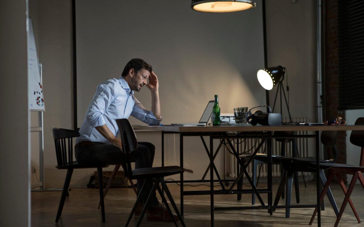 A stock photo of a businessman working late in an office - Westend61