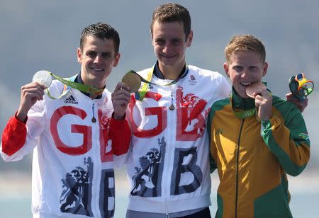 2016 Rio Olympics - Triathlon - Men's Victory Ceremony - Fort Copacabana - Rio de Janeiro, Brazil - 18/08/2016. Gold medalists Alistair Brownlee (GBR) of Great Britain, silver medalist Jonathan Brownlee (GBR) of Great Britain and bronze medalist Henri Schoeman (RSA) of South Africa pose with their medals. REUTERS/Damir Sagolj