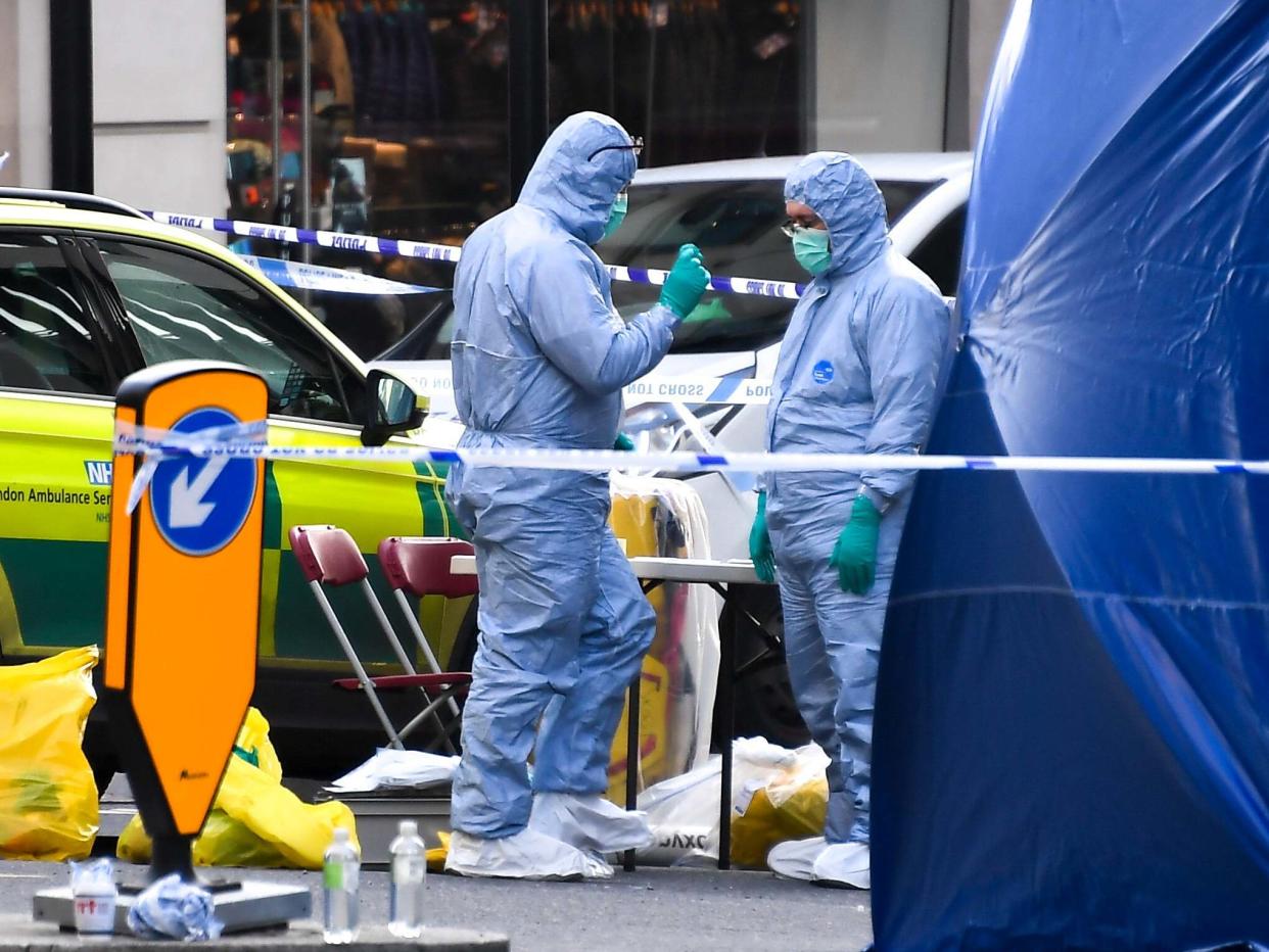 Forensic workers attend the scene on London Bridge in London: AP