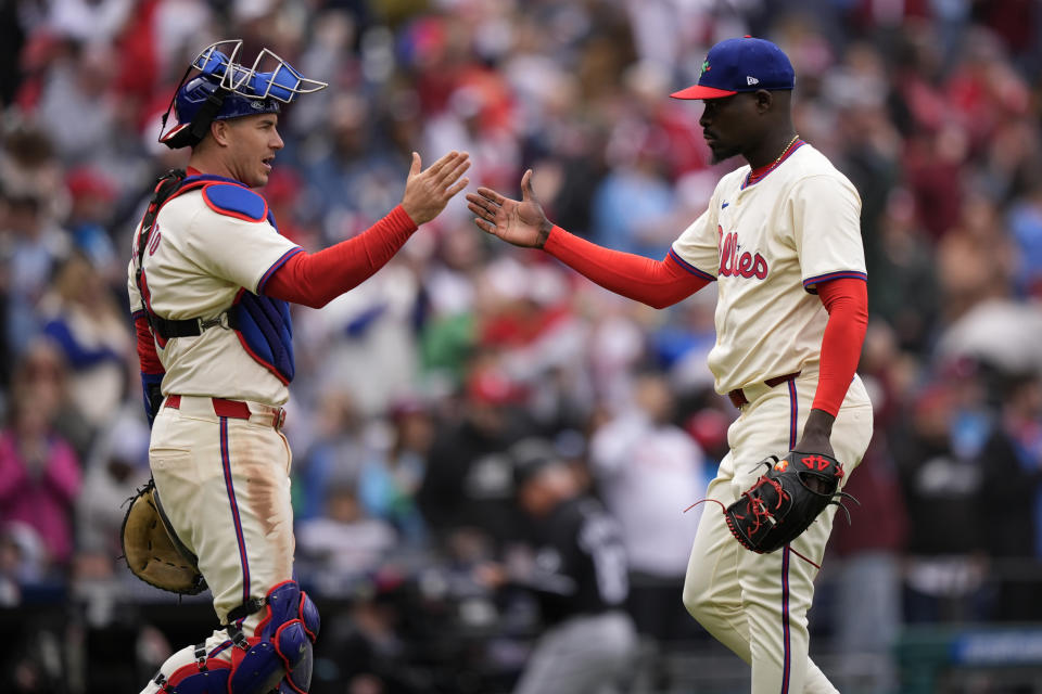 Philadelphia Phillies' J.T. Realmuto, left, and Yunior Marte celebrate after the Phillies won a baseball game against the Chicago White Sox, Sunday, April 21, 2024, in Philadelphia. (AP Photo/Matt Slocum)