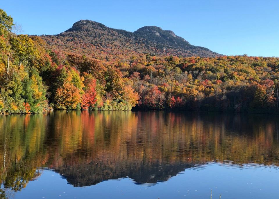Oct. 25: Fall color cascades down the lower slopes of Grandfather Mountain to the shores of nearby Grandfather Lake. This past weekend saw peak color throughout much of the WNC High Country, and experts anticipate elevations above 2,500 feet to follow suit this week.