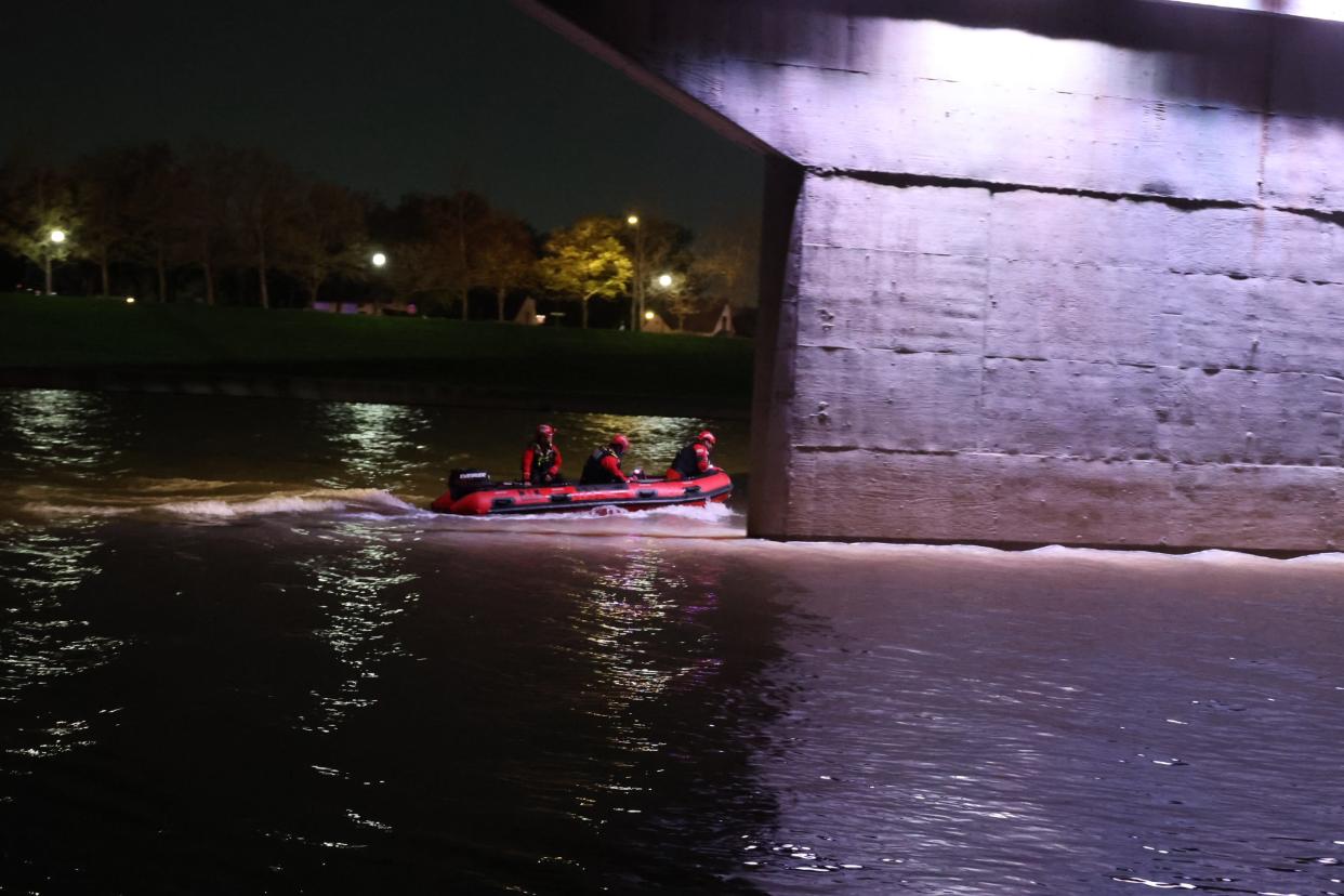 The Indianapolis Fire Department's dive team going into the White River near downtown to search for two missing kayakers about 9 p.m. Tuesday, April 16, 2024.