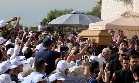 People use their mobile phones to take pictures of the coffin of Cardinal Nasrallah Sfeir, the former patriarch of Lebanon's Maronite church during his funeral in Bkerki, north of Beirut, Lebanon May 16, 2019. REUTERS/Aziz Taher
