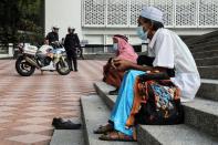 Police officers stand guard outside the closed National Mosque during Eid al-Fitr, the Muslim festival marking the end the holy fasting month of Ramadan, amid the coronavirus disease (COVID-19) outbreak in Kuala Lumpur