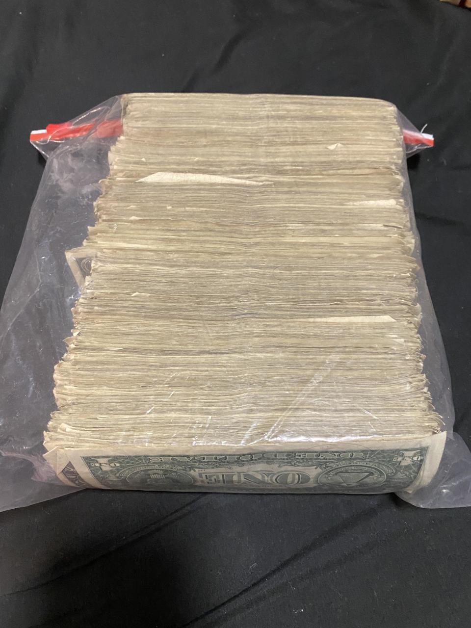 A stack of cash in a large ziplock bag