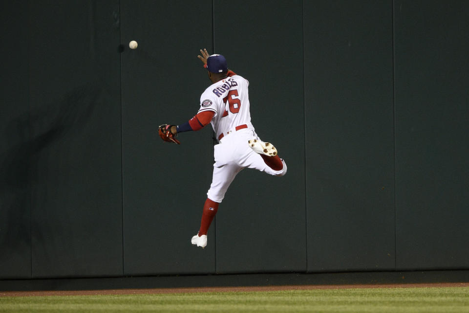 Washington Nationals center fielder Victor Robles misses the ball on a triple by St. Louis Cardinals' Dylan Carlson during the seventh inning of a baseball game Tuesday, April 20, 2021, in Washington. (AP Photo/Nick Wass)