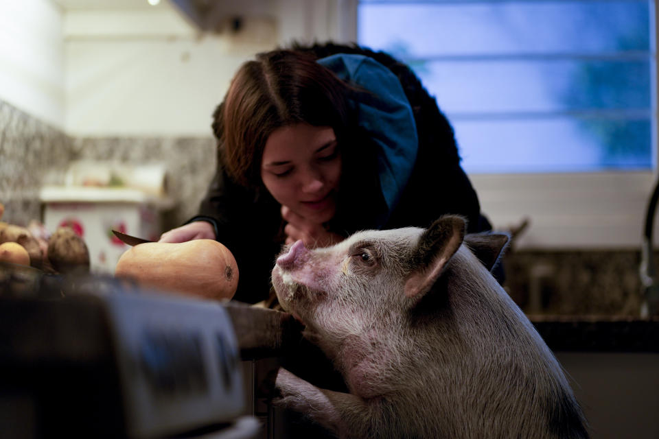 Luciana Benetti, 16, feeds her pet pig Chanchi, given to her as a birthday gift the previous year amid the COVID-19 pandemic in Buenos Aires, Argentina, Saturday, Sept. 4, 2021. “One day my legs gave way and he came running. He grabbed my hair and raised my head," she said. She had been taking online classes at home, unable to see friends or schoolmates. “I didn't feel well. I was dizzy because I couldn't leave.” (AP Photo/Natacha Pisarenko)