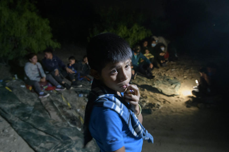 In a photo taken on March 27, 2021 unaccompanied Guatemalan child, Oscar (12), who arrived illegally across the Rio Grande river from Mexico, stands after disembarking from a boat near the US border city of Roma, Texas. (Ed Jones/AFP via Getty Images)