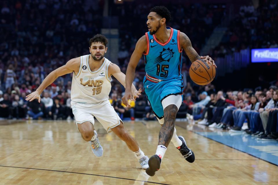Phoenix Suns guard Cameron Payne (15) drives against Cleveland Cavaliers guard Raul Neto (19) during the first half of an NBA basketball game, Wednesday, Jan. 4, 2023, in Cleveland. (AP Photo/Ron Schwane)