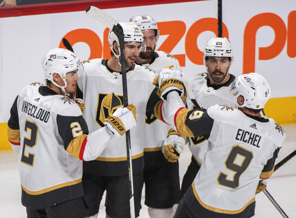 Vegas Golden Knights' Nicolas Hague (14) celebrates with teammates after scoring against the Montreal Canadiens during the first period of an NHL hockey game Saturday, Nov. 5, 2022, in Montreal. (Graham Hughes/The Canadian Press via AP)