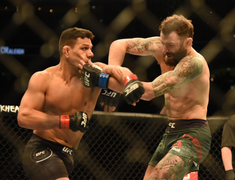 Jan 25, 2020; Raleigh, NC, USA; Michael Chiesa (blue gloves) and Rafael Dos Anjos (red gloves) during UFC Fight Night at PNC Arena. Mandatory Credit: Rob Kinnan-USA TODAY Sports