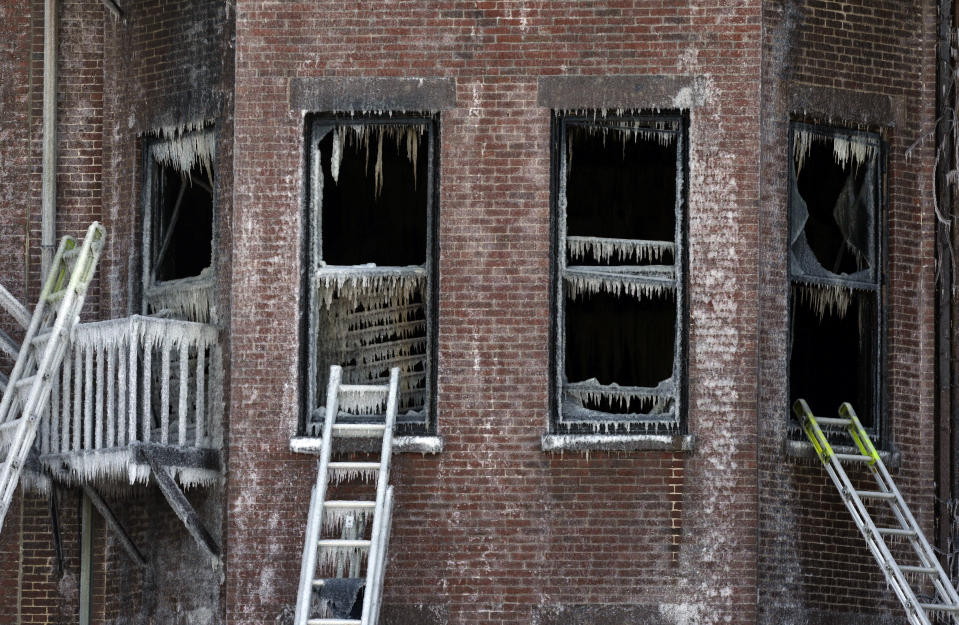 FILE - Ladders lean against burned remains of a four-story brownstone, March 27, 2014, in Boston. A decade after two firefighters died when they became trapped in the brownstone in Boston’s historic Back Bay neighborhood by a fire caused by sparks from welders working on a building next door, the Massachusetts Senate passed a bill Thursday, March 28, 2024, aimed at toughening oversight of so-called “hot work." (AP Photo/Steven Senne, File)