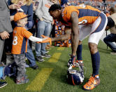 <p>Denver Broncos wide receiver Demaryius Thomas (88) greets a young fan prior to an NFL football game against the Cincinnati Bengals, Sunday, Nov. 19, 2017, in Denver. (AP Photo/Jack Dempsey) </p>