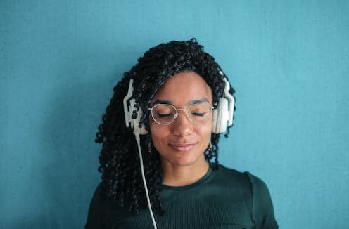 <span class="caption">Listening to certain songs can trigger some pretty intense memories.</span> <span class="attribution"><a class="link " href="https://www.pexels.com/photo/portrait-photo-of-smiling-woman-in-black-top-and-glasses-wearing-white-headphones-3765147/" rel="nofollow noopener" target="_blank" data-ylk="slk:Pexels/Andrea Piacquadio;elm:context_link;itc:0;sec:content-canvas">Pexels/Andrea Piacquadio</a></span>