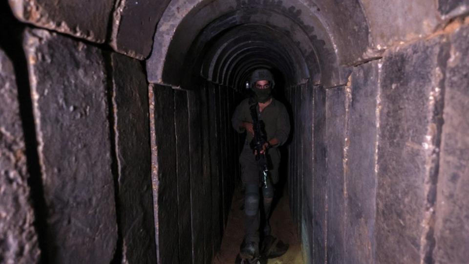 An Israeli soldier walks through a captured Hamas tunnel