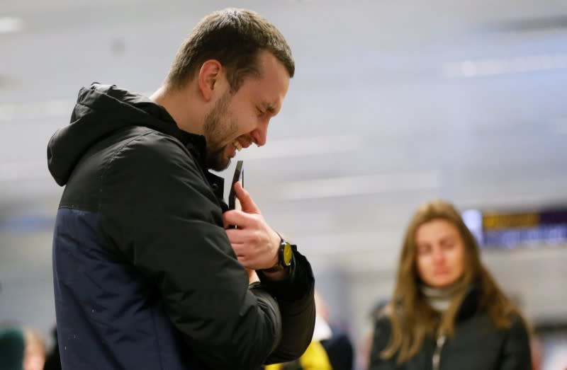A relative of the flight crew member of the Ukraine International Airlines Boeing 737-800 plane that crashed in Iran, mourns at the Boryspil International airport