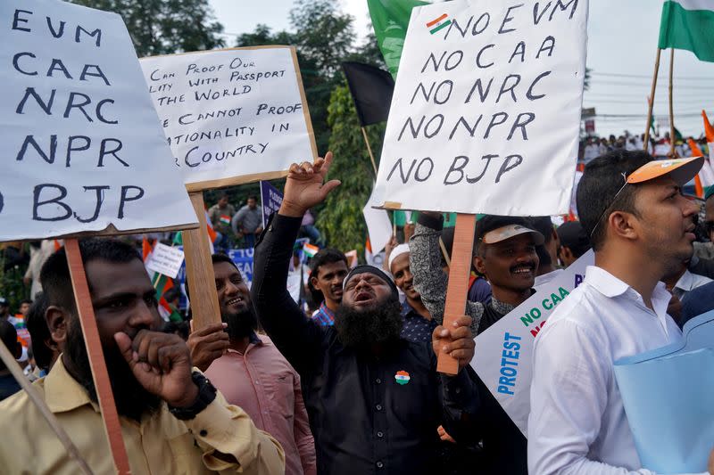 Demonstrators holding placards shout slogans as they attend a protest rally against a new citizenship law, in Hyderabad