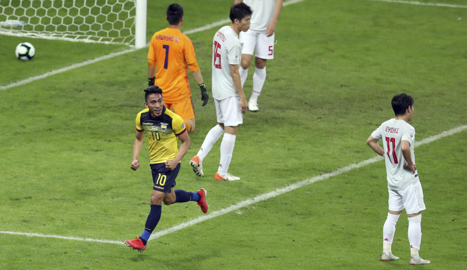 Ecuador's Angel Mena, left, celebrates scoring his team's equalizer against Japan during a Copa America Group C soccer match at the Mineirao stadium in Belo Horizonte, Brazil, Monday, June 24, 2019. (AP Photo/Natacha Pisarenko)