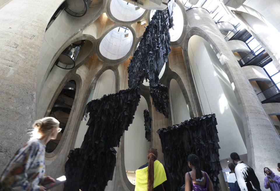 An installation by Malagasy artist Joel Andrianomearisoa "The Five Continents of All Our Desires," is seen in the Zeitz Museum of Contemporary Art Africa in Cape Town, South Africa, Wednesday, Sept. 7, 2022. The work transforms the towering atrium of the museum with black silk paper suspended in the museum's multi-story central atrium.(AP Photo/Nardus Engelbrecht)