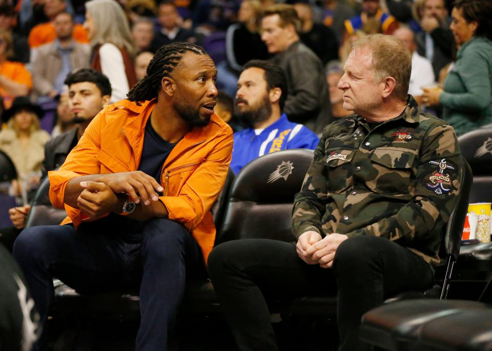 Phoenix Suns minority owner and Arizona Cardinals wide receiver Larry Fitzgerald talks with owner Robert Sarver during the third quarter against the Golden State Warriors at Talking Stick Resort Arena February 12, 2019.