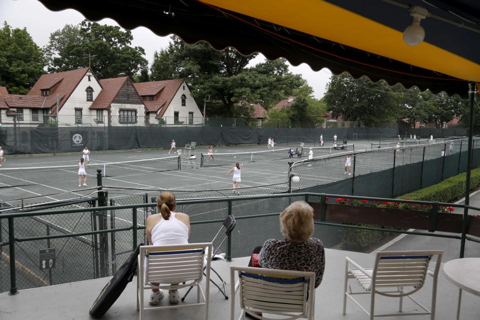 In this Tuesday, July 2, 2013 photo, women play tennis at the West Side Tennis Club in the Queens section of New York. The Beatles. The Rolling Stones. Frank Sinatra. Jimi Hendrix. Bob Dylan. They’ve all held court at the more than century-old West Side Tennis Club in Queens’ Forest Hills neighborhood - for six decades the site of the U.S. Open Tennis Championships. Plans are now in the works for the grassy lawn to come alive again with the sound of music, starting with a concert featuring the British band Mumford & Sons, to be followed by a lineup of world-class musicians. (AP Photo/Seth Wenig)