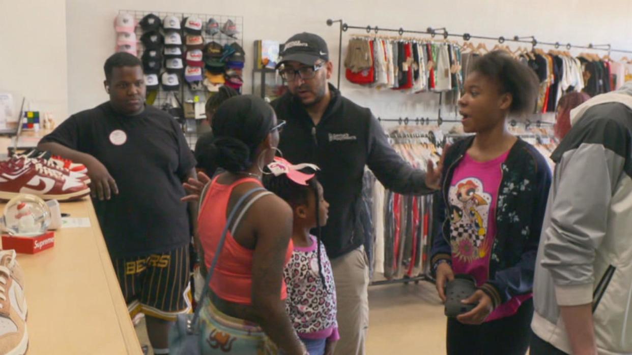 PHOTO: Sam Sayed greets kids at a shoe store. (ABC News)