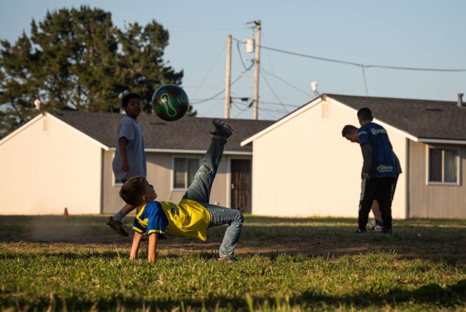 Children practice bicycle kicks and play soccer at the Buena Vista Migrant Center outside of Watsonville in May.