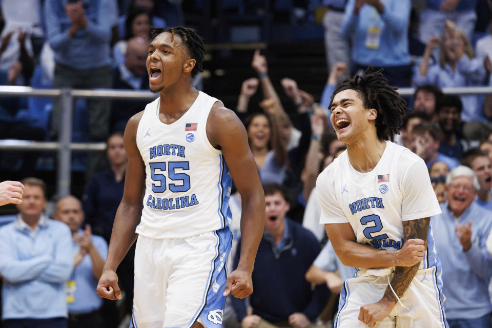 North Carolina's Elliot Cadeau (2) and Harrison Ingram (55) celebrate after a play during the second half of an NCAA college basketball game against Florida State in Chapel Hill, N.C., Saturday, Dec. 2, 2023. (AP Photo/Ben McKeown)