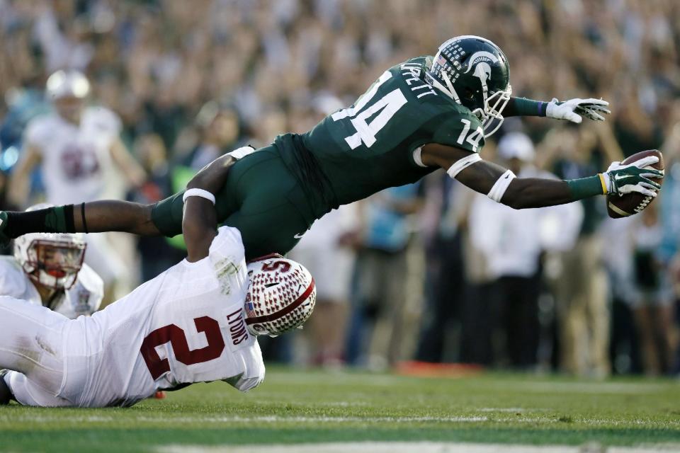 Michigan State wide receiver Tony Lippett scores a touchdown against Stanford's Wayne Lyons during the second half of the Rose Bowl NCAA college football game Wednesday, Jan. 1, 2014, in Pasadena, Calif. (AP Photo/Danny Moloshok)