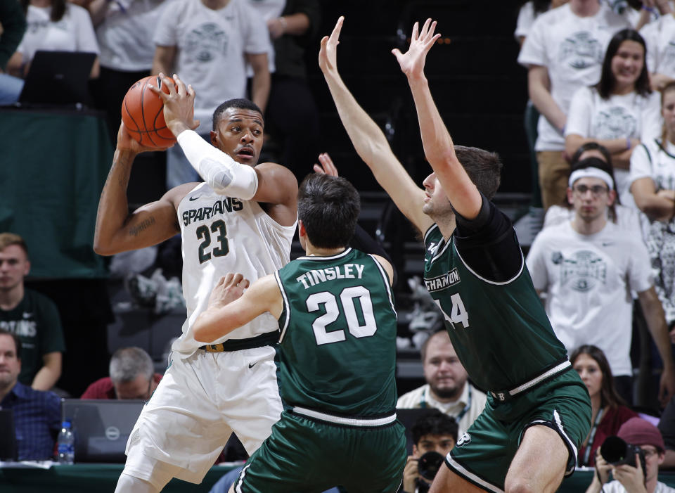 Michigan State's Xavier Tillman, left, maneuvers against Binghamton's George Tinsley, center, and Yarden Willis, right, during the first half of an NCAA college basketball game Sunday, Nov. 10, 2019, in East Lansing, Mich. (AP Photo/Al Goldis)