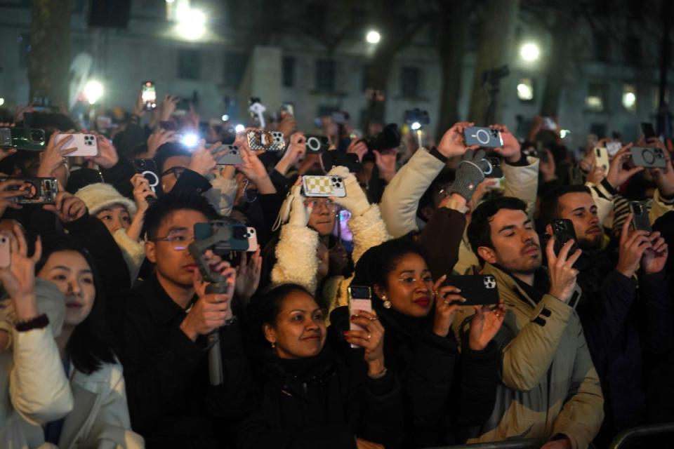 People record and take pictures of the fireworks over the London Eye (PA)