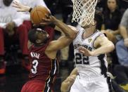 Miami Heat's Dwyane Wade (L) goes up to shoot against San Antonio Spurs' Tiago Splitter of Brazil in Game 1 of their NBA Finals basketball series in San Antonio, Texas June 5, 2014. REUTERS/Mike Stone (UNITED STATES - Tags: SPORT BASKETBALL)