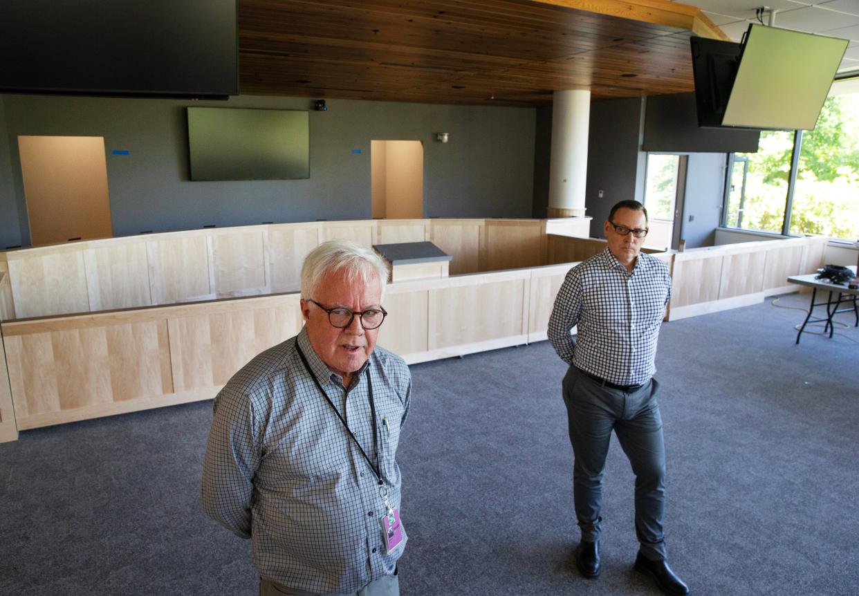 Loren Berry, left, and Jeff Perry lead a tour of the new Eugene City Hall Council Chambers as the remodel of the old EWEB headquarters nears completion. The city council is scheduled to host its first meeting in its new council chambers this Monday.