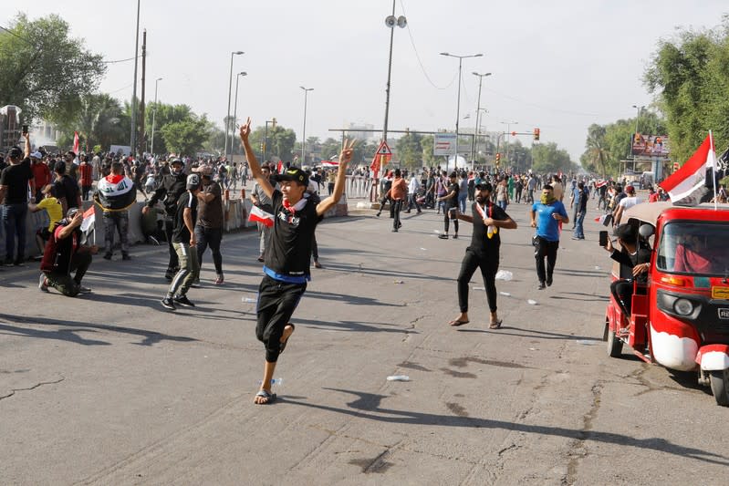 Demonstrators are seen during a protest over corruption, lack of jobs, and poor services, in Baghdad