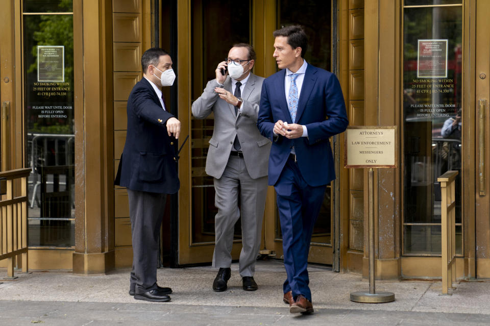 Kevin Spacey, center, leaves court after testifying in a civil lawsuit, Thursday, May 26, 2022, in New York. British prosecutors have charged Spacey with four counts of sexual assault against three men. The 62-year-old double Academy Award winner was questioned by British police in 2019 about claims by several men that he had assaulted them. The U.K. charges were announced Thursday, as Spacey was testifying in a courtroom in New York City in a civil lawsuit. (AP Photo/John Minchillo)