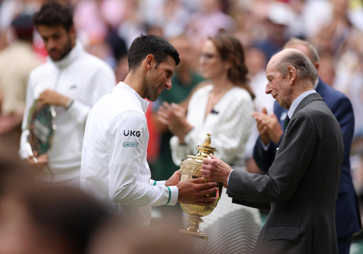 LONDON, ENGLAND - JULY 11: Novak Djokovic of Serbia is presented with the trophy by Prince Edward, Duke of Kent after winning his men's Singles Final match against Matteo Berrettini of Italy on Day Thirteen of The Championships - Wimbledon 2021 at All England Lawn Tennis and Croquet Club on July 11, 2021 in London, England. (Photo by Steven Paston - Pool/Getty Images)