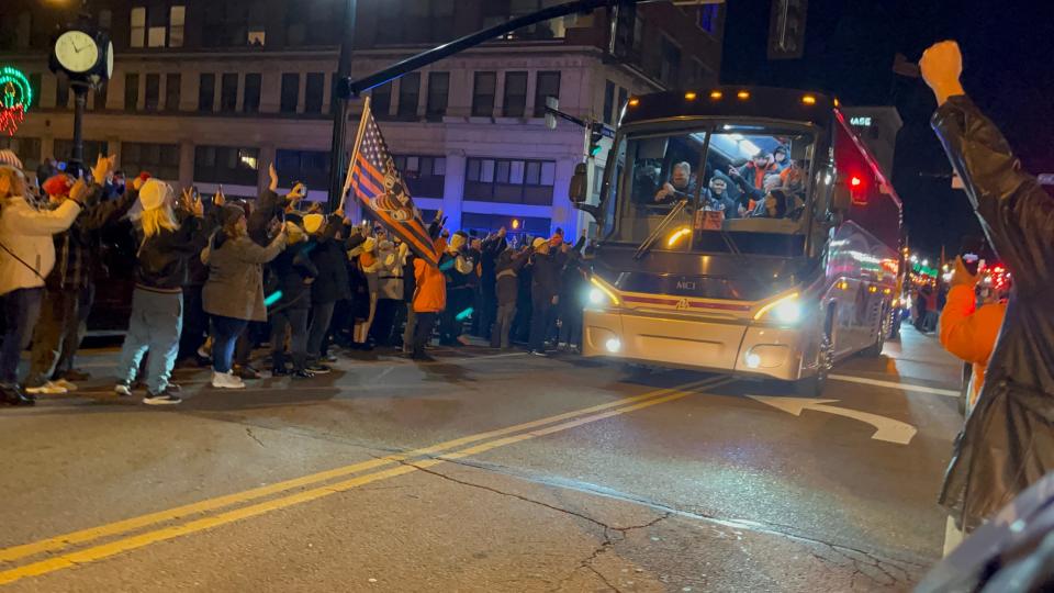 Fans greet in downtown Massillon the return of the state-champion Washington High School Massillon Tigers football team Thursday night after the game.