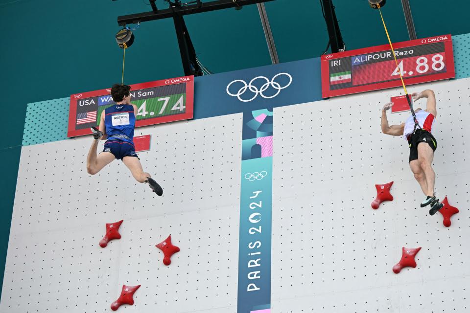 American Sam Watson (left) wins ahead of Iranian Reza Alipour Shenazandifard in the men's speed climbing bronze race during the Paris 2024 Olympic Games at Le Bourget sport climbing stadium on August 8, 2024. (Photo by Jonathan NACKSTRAND / AFP) (Photo by JONATHAN NACKSTRAND/AFP via Getty Images)