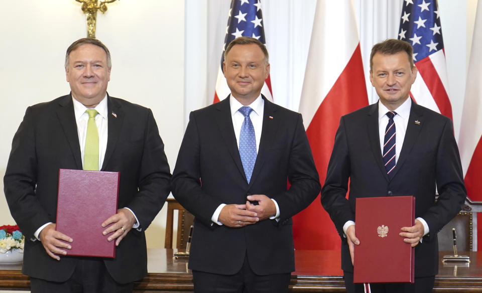 US Secretary of State Mike Pompeo, left, Poland's President Andrzej Duda, center, and Poland's Minister of Defence Mariusz Blaszczak pose for the media after signing the US-Poland Enhanced Defence Cooperation Agreement in the Presidential Palace in Warsaw, Poland, Saturday Aug. 15, 2020. Pompeo is on a five day visit to central Europe. (Janek Skarzynski/Pool via AP)