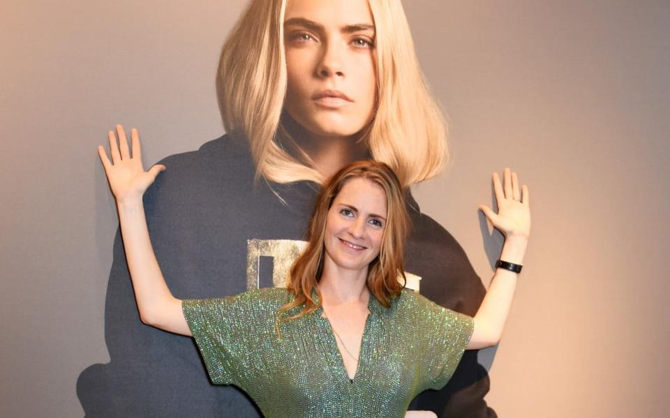 Chloe Delevingne in front of an image of her sister Cara at the launch of the Lady Garden x Topshop collection in support of the Gynaecological Cancer Fund - Getty Images Europe