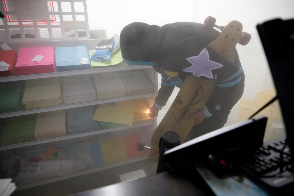 A person lights a fire in an office supply store in Minneapolis, Minn., on May 29, 2020. | John Minchillo—AP