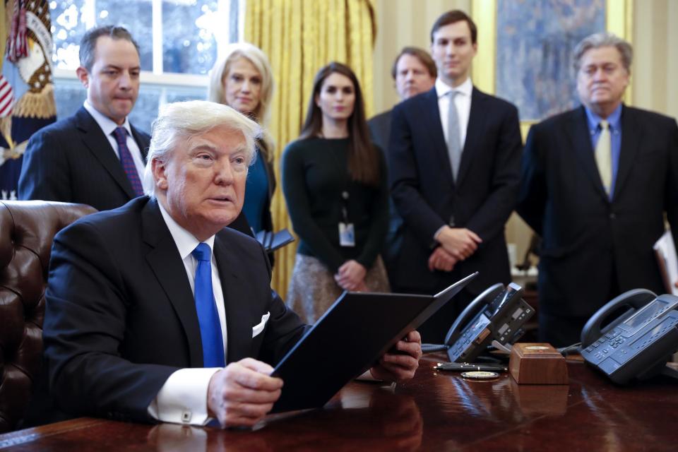 President Donald Trump signs one of five executive orders related to the oil pipeline industry in the Oval Office of the White House, 24 January, 2017 in Washington, DC (Shawn Thew-Pool/Getty Images)