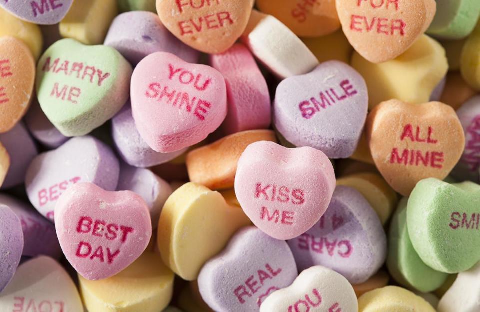 Why do candy hearts have phrases on them?