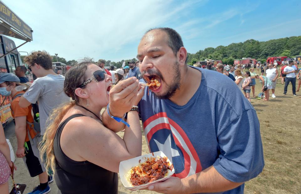 Melynda and Dan Hernandez of Lakeville find the wait is worth it for the pulled rib meat in mac and cheese at a popular truck at last year's Cape Cod Food Truck & Craft Beer Festival in East Falmouth.