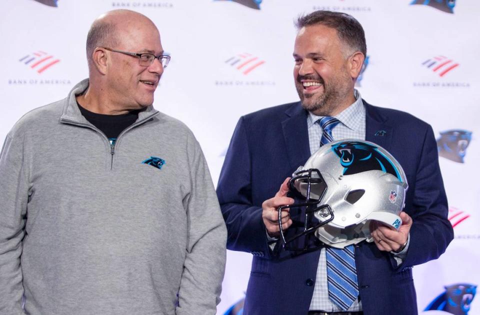 Panthers owner David Tepper and head coach Matt Rhule laugh in January 2020, shortly after Tepper hired Rhule to coach the team.