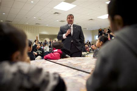 New Jersey Governor Chris Christie meets students before making an education announcement involving a new after-school dinner program for students in need at Dudley Family School in Camden, New Jersey January 23, 2014. REUTERS/Mark Makela