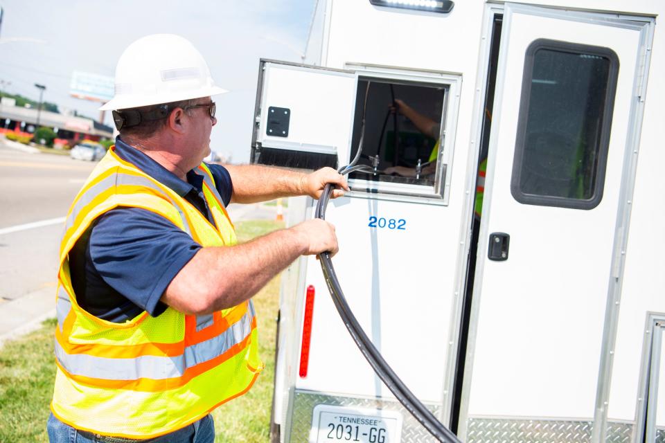 KUB’s Eric Rhyno feeds a fiber cable into a trailer to be spliced as KUB installs fiber between two Knoxville substations as part of the utility’s efforts to continue improving its electrical system on Monday, May 24, 2021.
