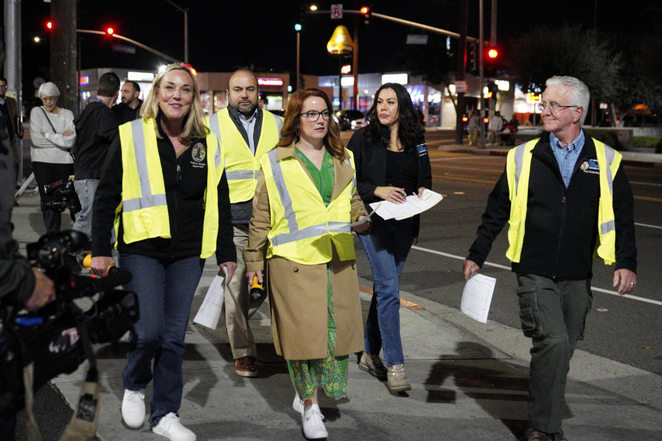Los Angeles City Council President Paul Krekorian, right, joined by Kathryn Barger, left, representing the 5th supervisorial district of Los Angeles County and Supervisor Lindsey P. Horvath, center, who represents the 3rd supervisorial district of Los Angeles County, walk on the street at the start of the annual homeless count in the North Hollywood section of Los Angeles Tuesday, Jan. 23, 2024. (AP Photo/Richard Vogel)