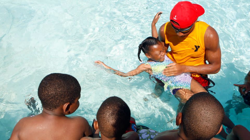 Children get a swimming lesson at a YMCA in Memphis, Tennessee.  Research shows participation in formal swimming lessons can reduce the risk of drowning.  - Karen Pulfer Focht/The Commercial Appeal/AP